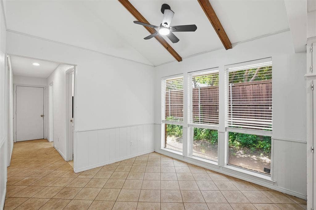 1000 Lexington Drive, Plano, TX 75075 Room featuring a vaulted ceiling with exposed wood beams, a modern ceiling fan, and large windows with blinds