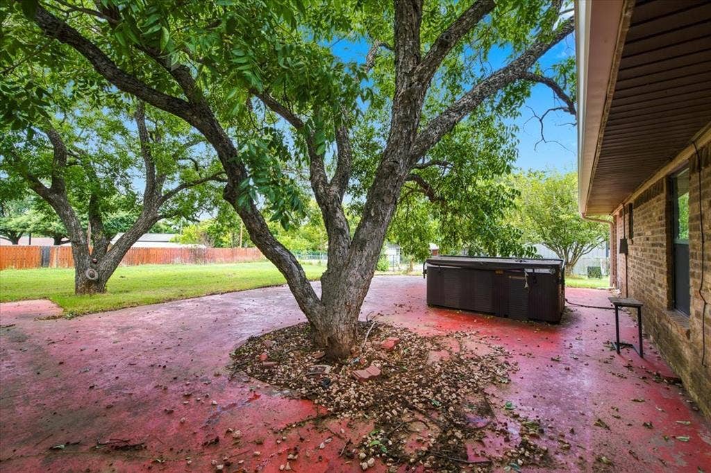 612 W Highland Street, West, TX 76691 Back patio area with bountiful shade and a hot tub (that needs repair)