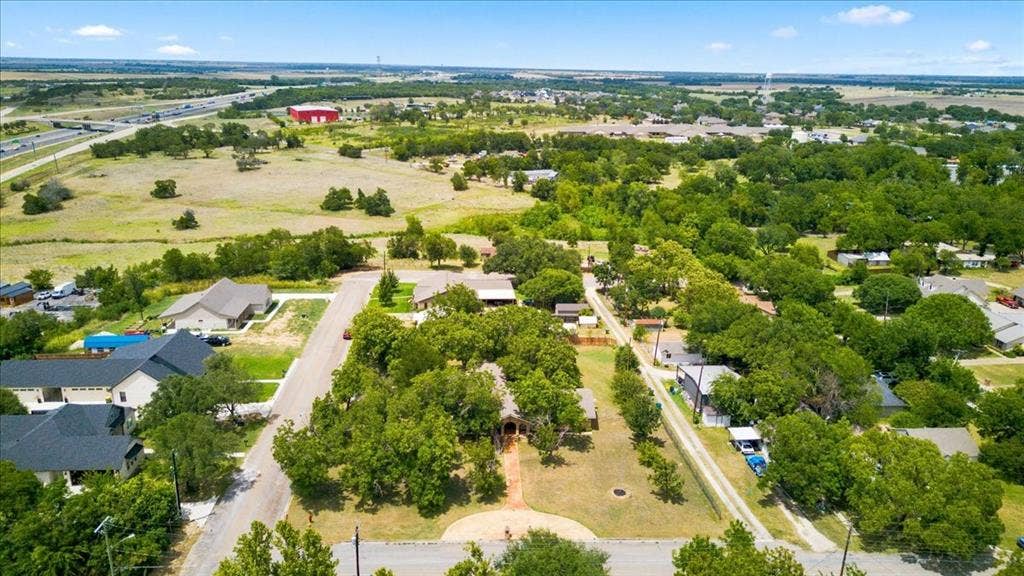 612 W Highland Street, West, TX 76691 Aerial perspective showcasing a residential street with mature trees