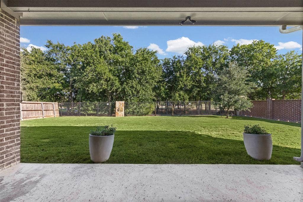 3200 Tail Water Drive, Mansfield, TX 76063 Enjoy your morning coffee on this huge covered patio looking at the trees