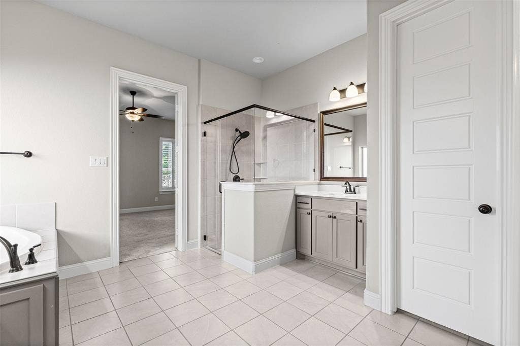 3200 Tail Water Drive, Mansfield, TX 76063 Massive primary bathroom has separate vanities, shower, garden tub, and two huge closets, one that connects to the laundry room