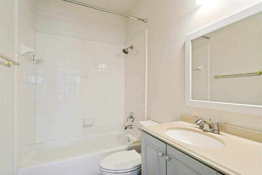 8512 Mesa Verde Drive, Plano, TX 75025 Bathroom featuring a full vanity with a light gray cabinet, a white oval sink, and a light-toned countertop