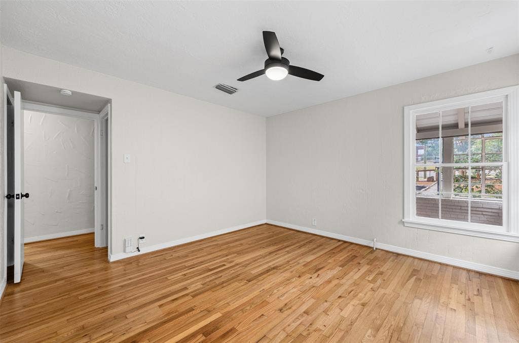 311 N Tennant Street, Dallas, TX 75208 Bedroom with hardwoods and ceiling fan