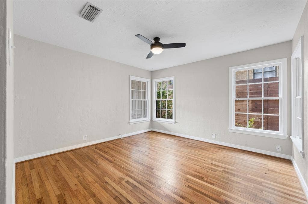 311 N Tennant Street, Dallas, TX 75208 Bedroom with hardwoods and ceiling fan