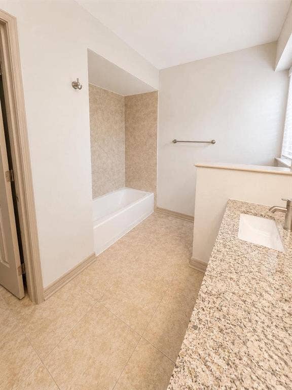 7806 Williams Avenue, Frisco, TX 75033 Bathroom featuring a full vanity with an integrated sink, polished chrome faucet, and stone-finish countertop