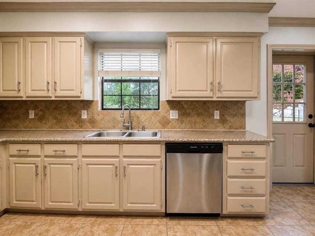 7806 Williams Avenue, Frisco, TX 75033 Kitchen featuring light-toned cabinetry, a stainless steel double basin sink, and a stainless steel dishwasher