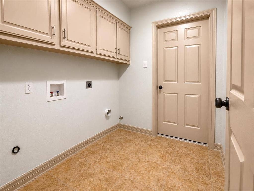 7806 Williams Avenue, Frisco, TX 75033 Laundry area featuring neutral-toned cabinetry, tile flooring, and a paneled door