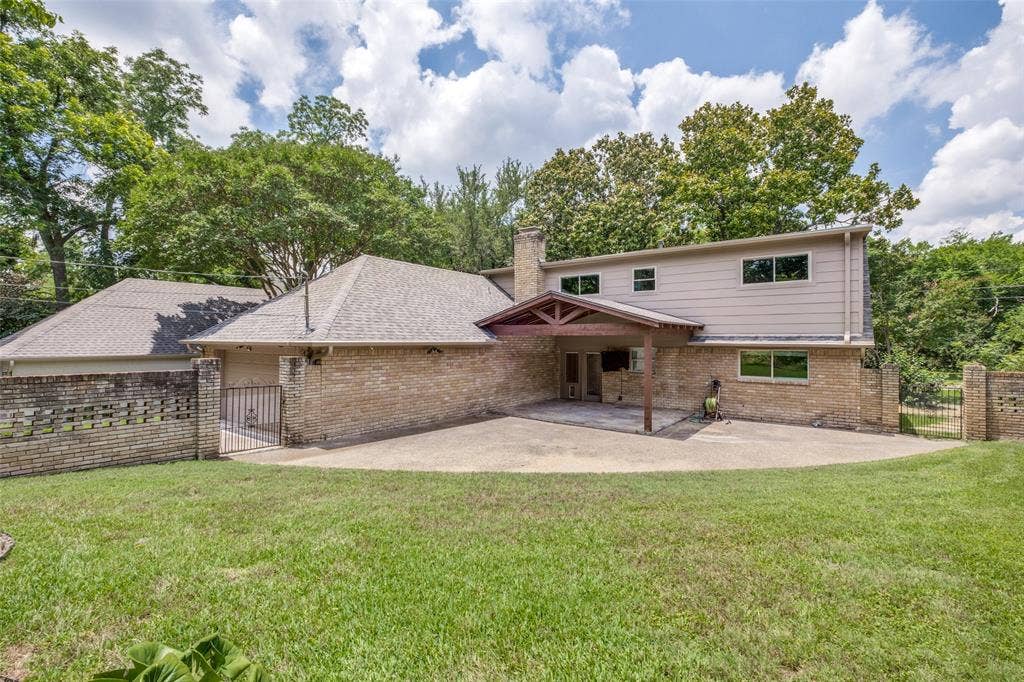 12022 Dixfield Drive, Dallas, TX 75218 Charming backyard with a generous covered patio, offering an inviting space to unwind.