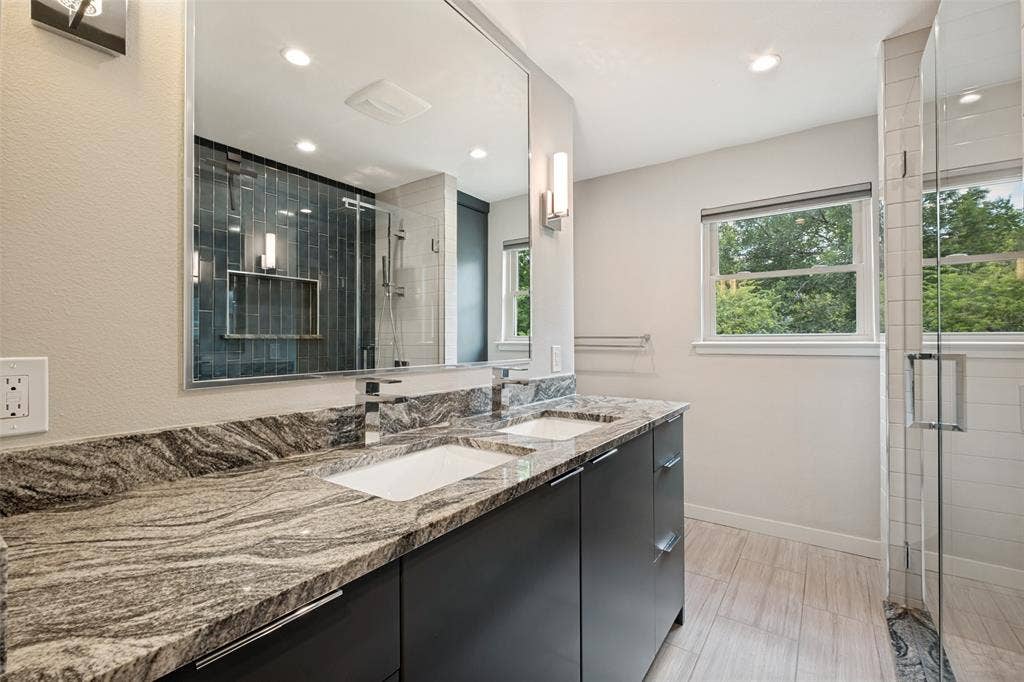 12022 Dixfield Drive, Dallas, TX 75218 Updated upstairs bathroom featuring refreshed finishes and a clean, modern feel.
