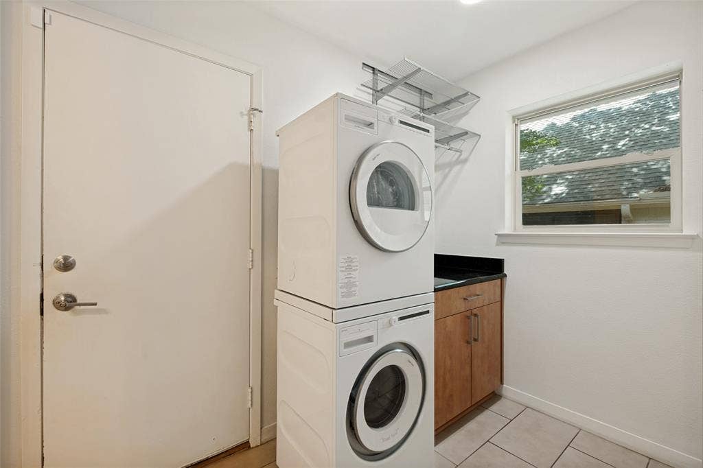 12022 Dixfield Drive, Dallas, TX 75218 Laundry room with built in cabinetry and two ample storage pantries.