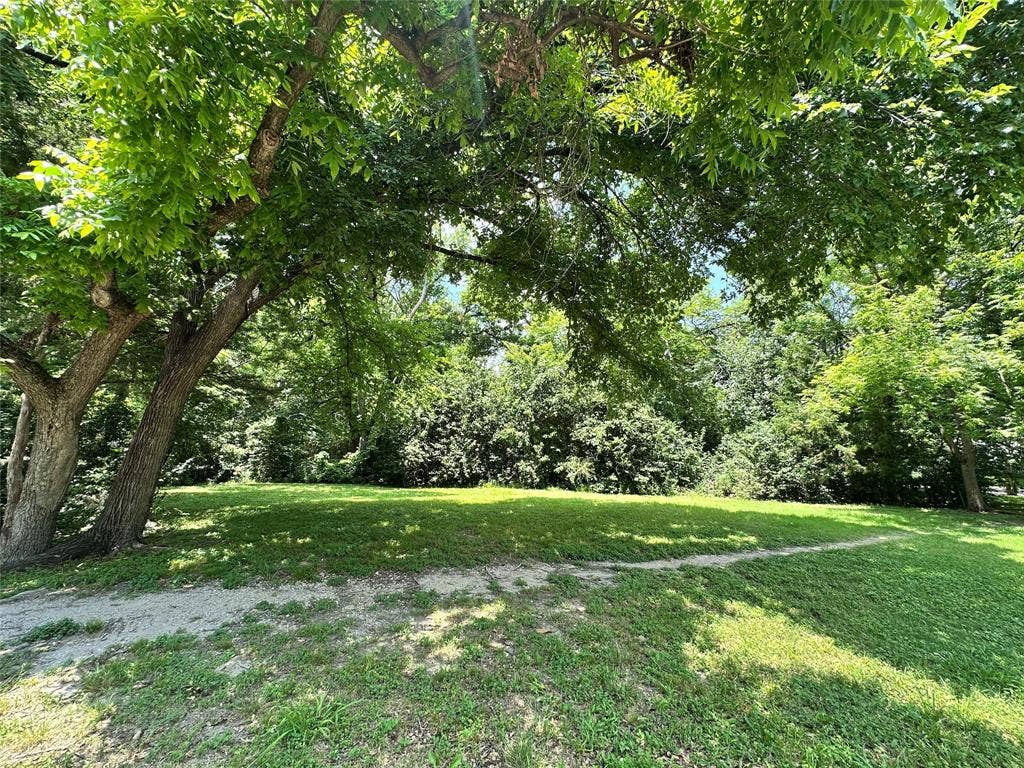 12022 Dixfield Drive, Dallas, TX 75218 Enjoy peaceful views of the greenbelt just across the street.