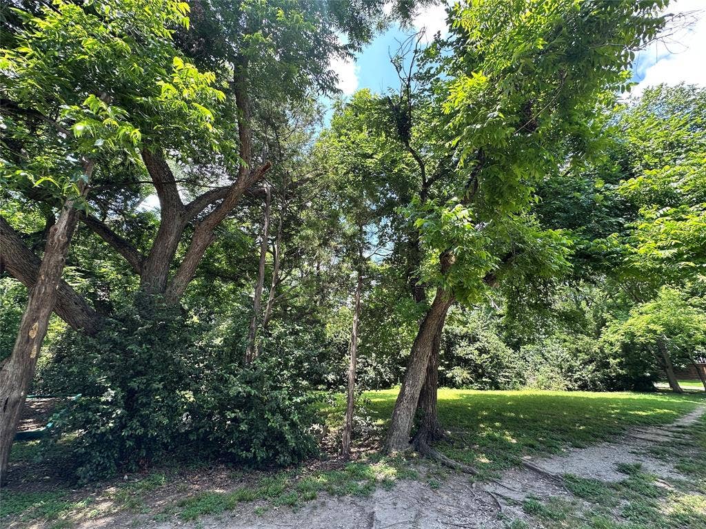 12022 Dixfield Drive, Dallas, TX 75218 The home’s setting across from a greenbelt creates a sense of openness and added privacy.