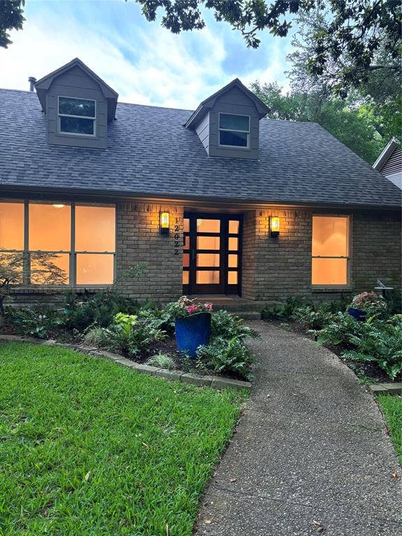 12022 Dixfield Drive, Dallas, TX 75218 Beautifully landscaped front yard featuring mature trees and outdoor lighting that enhances the home’s curb appeal.