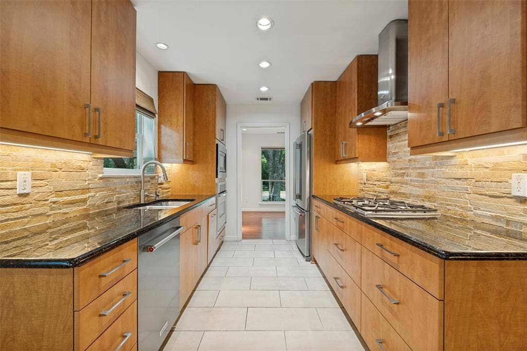 12022 Dixfield Drive, Dallas, TX 75218 Bright, updated kitchen with abundant cabinetry and counter space which is complemented by a window above the sink that brings in natural light.