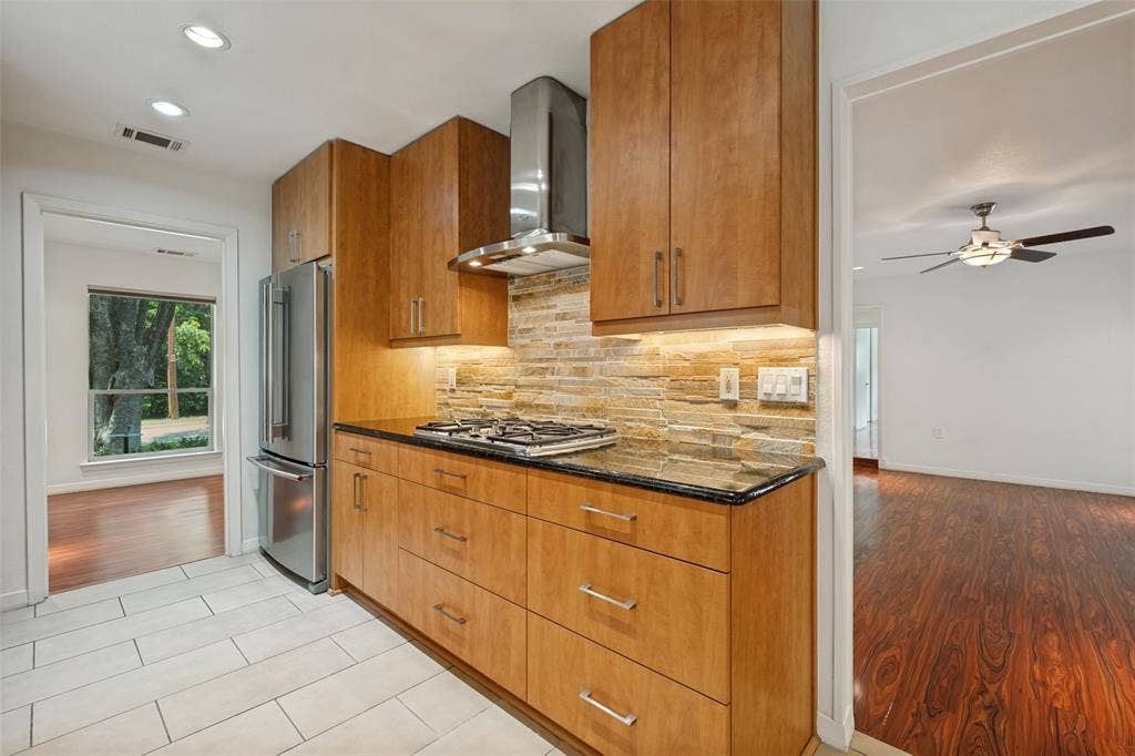 12022 Dixfield Drive, Dallas, TX 75218 Updated kitchen designed for everyday living and easy entertaining featuring a gas cooktop.