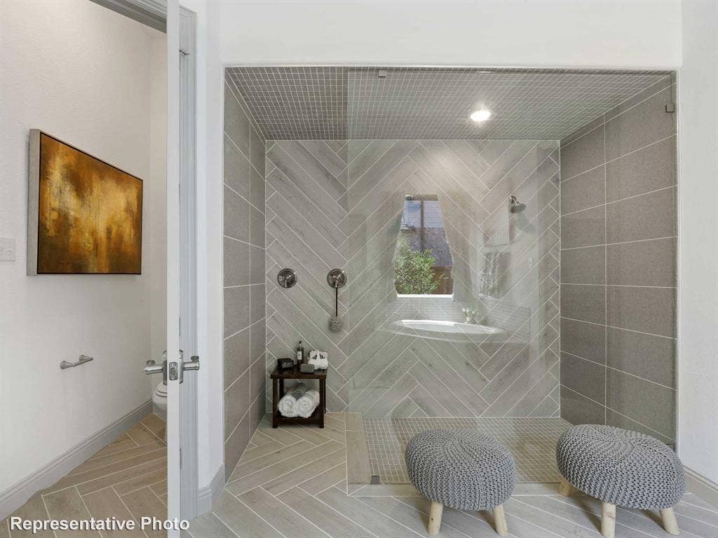 4359 Michigan Avenue, Midlothian, TX 76065 Spacious shower enclosure featuring herringbone-patterned wall tile, glass shower panel, and a built-in shelf