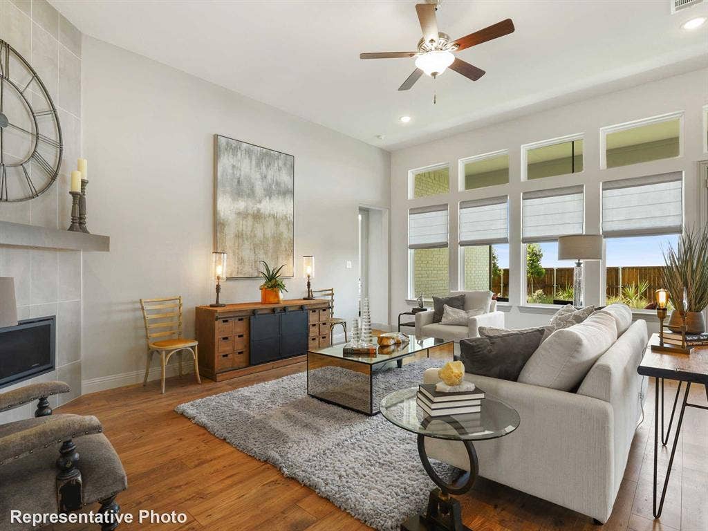 4359 Michigan Avenue, Midlothian, TX 76065 Spacious living area featuring high ceilings, wood-finish flooring, and a ceiling fan with integrated lighting