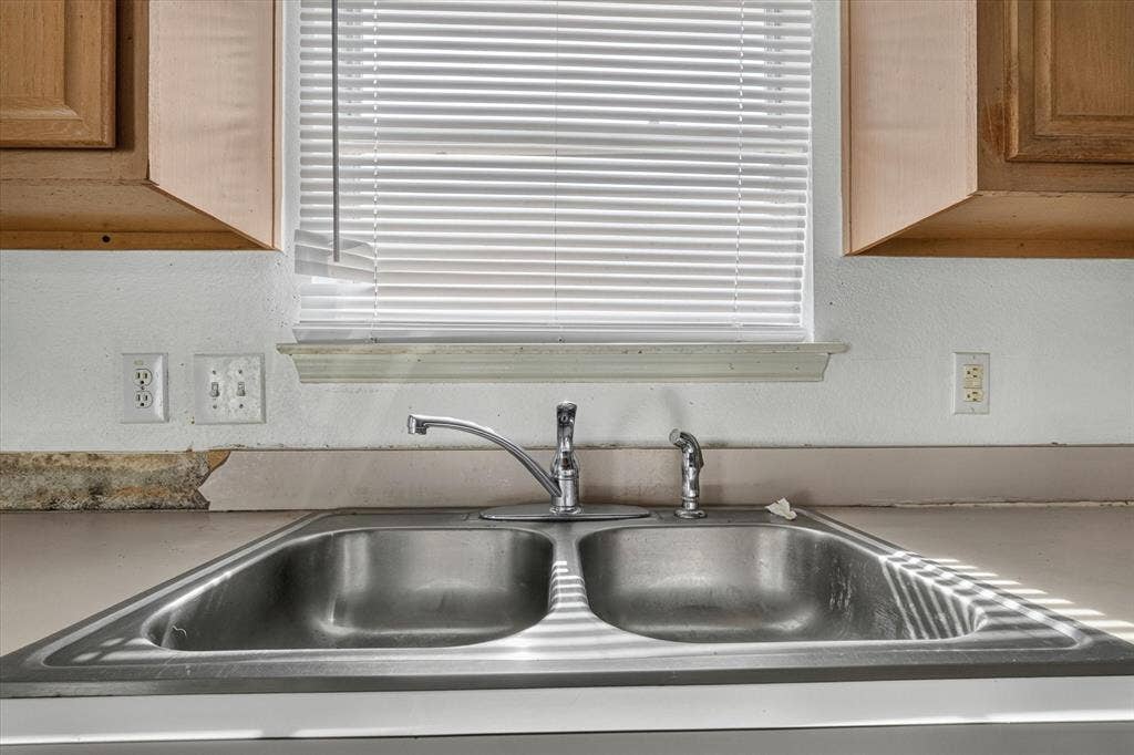 1414 Aviary Drive, DeSoto, TX 75115 Stainless steel double basin sink with a chrome faucet