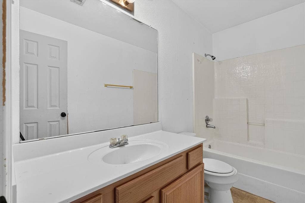 1414 Aviary Drive, DeSoto, TX 75115 Bathroom featuring a light wood-finish vanity with a white countertop and integrated sink