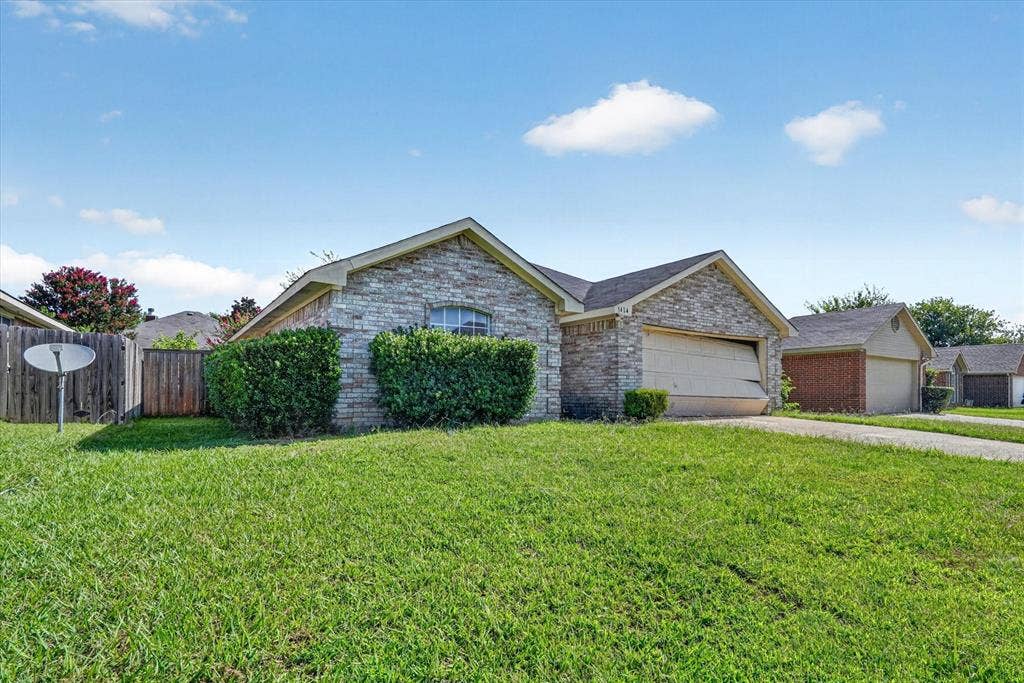 1414 Aviary Drive, DeSoto, TX 75115 Stone veneer facade with a single-car garage and arched window