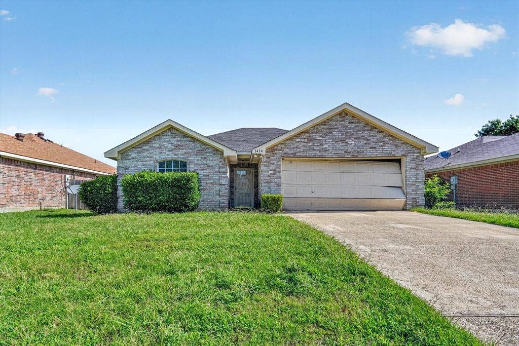 1414 Aviary Drive, DeSoto, TX 75115 Single-story residence featuring a stone veneer facade, a dark shingle roof, and an attached garage