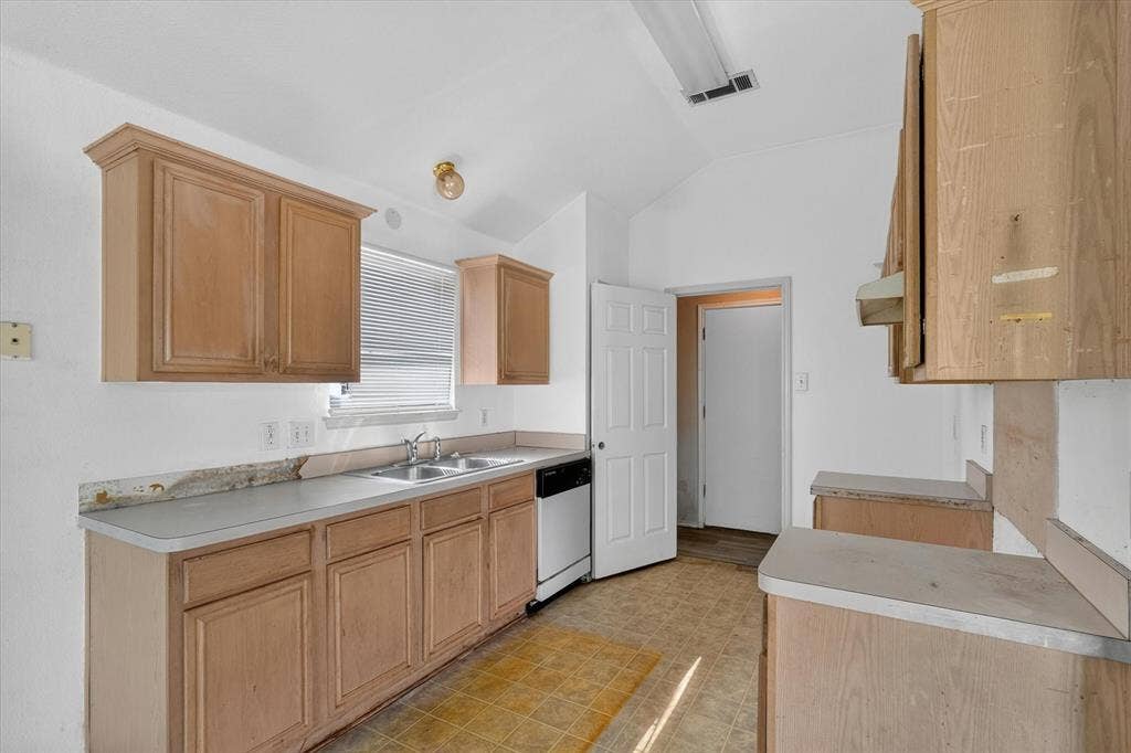 1414 Aviary Drive, DeSoto, TX 75115 Kitchen featuring light wood cabinetry and light-toned countertops