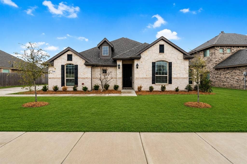 6206 Allison Drive, Midlothian, TX 76065 Stone veneer exterior with dark shingle roof. Grass as been Ai enhanced.