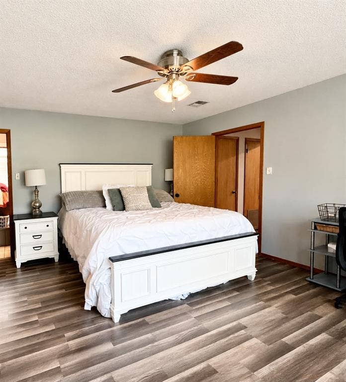 7761 Fm 2494, Athens, TX 75751 Spacious room featuring wood-finish flooring, a ceiling fan with integrated lighting, and a neutral wall color