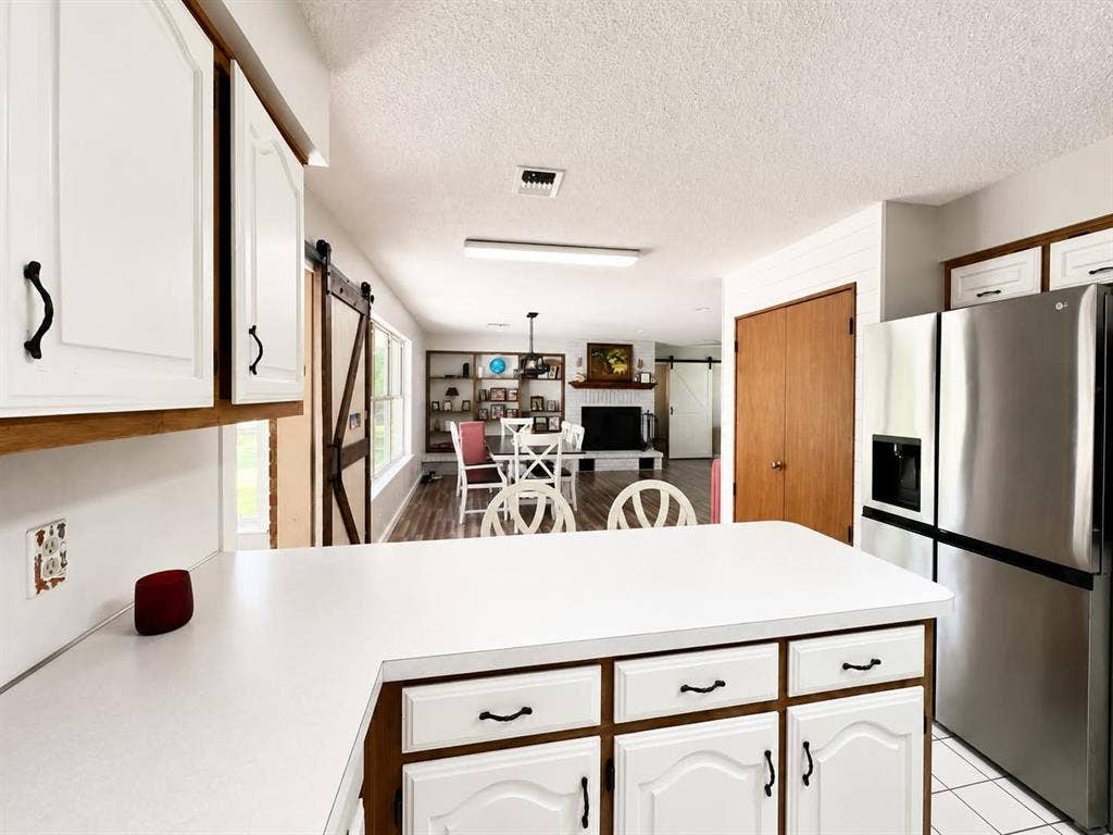 7761 Fm 2494, Athens, TX 75751 Kitchen island with white countertop and white cabinetry with black hardware