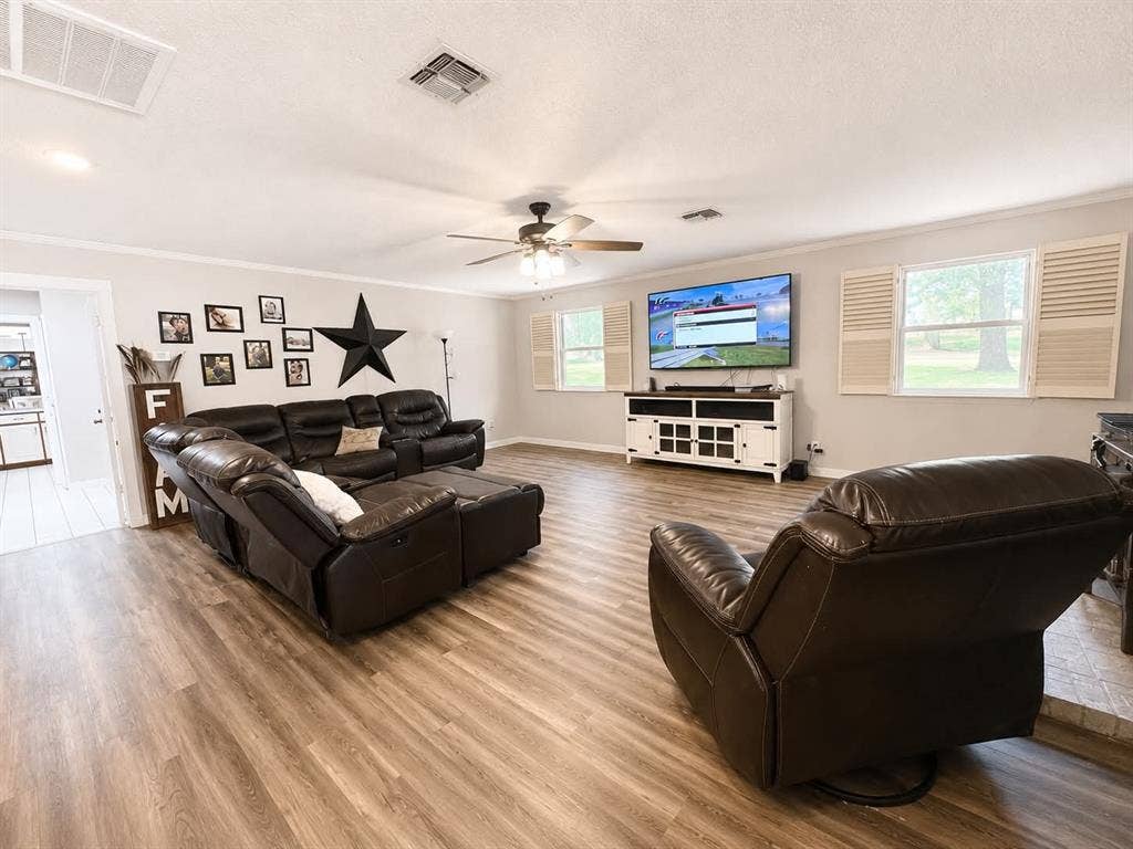 7761 Fm 2494, Athens, TX 75751 Spacious living area featuring wood-finish flooring, light gray walls, white trim, and a ceiling fan