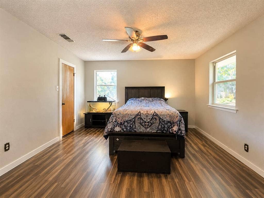 7761 Fm 2494, Athens, TX 75751 Spacious room featuring wood-finish flooring, light neutral wall paint, and two single-pane windows