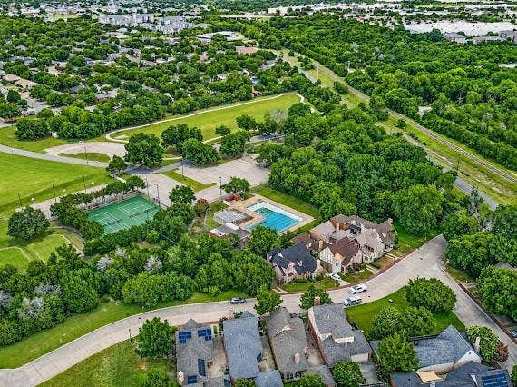 Expansive aerial view showcasing a neighborhood with extensive green spaces