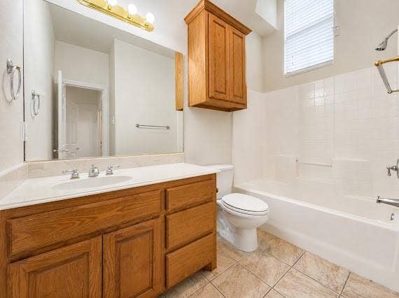 Bathroom vanity with a light-colored countertop, integrated sink, and chrome faucet