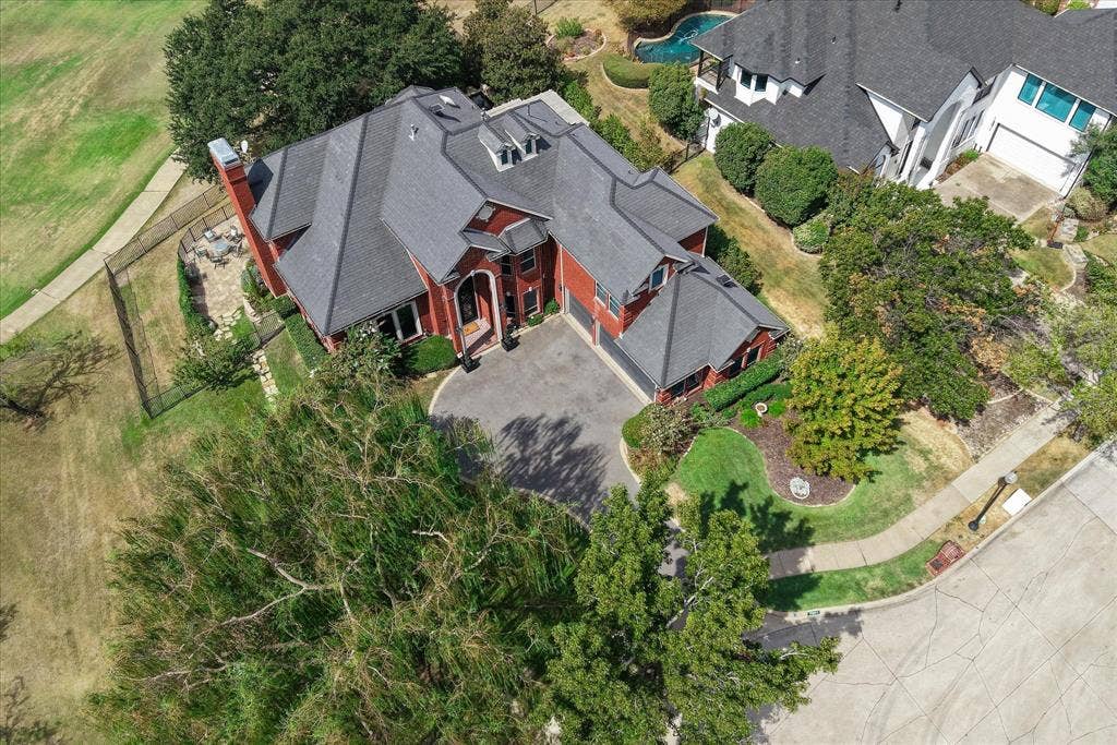 7501 Sweetgum Drive, Irving, TX 75063 Red brick exterior with a multi-gabled roof and dormer windows