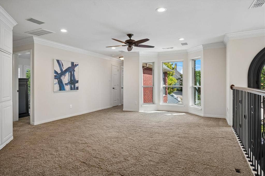7501 Sweetgum Drive, Irving, TX 75063 Recessed lighting, ceiling fan, bay windows, built-in cabinetry, and wrought iron railing