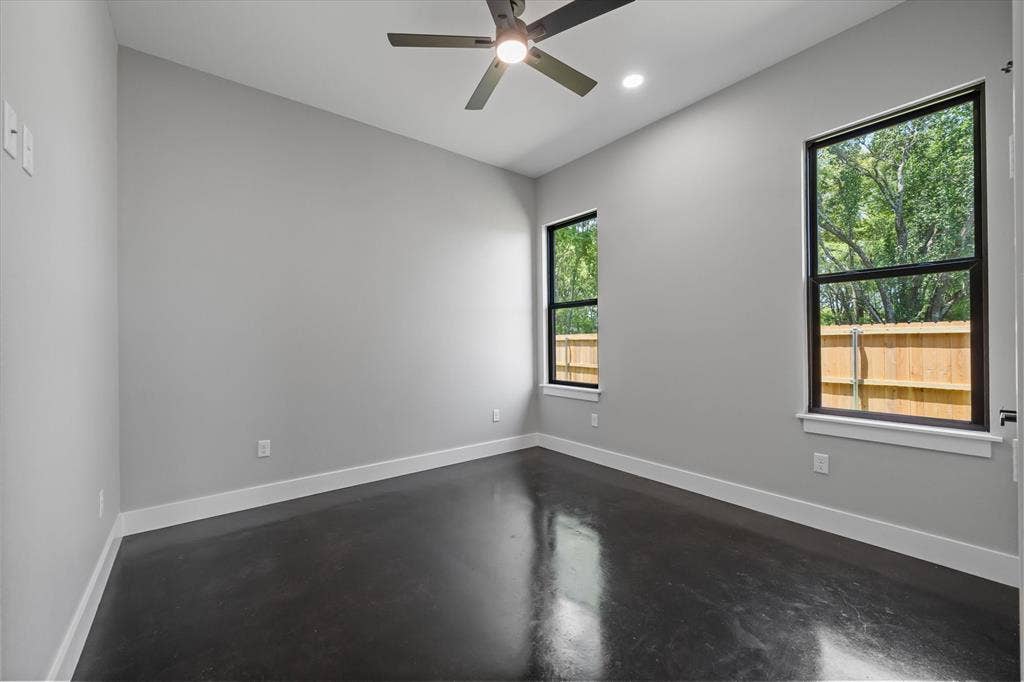12253 Madison Xing, Bullard, TX 75757 Spacious room featuring dark polished concrete flooring, white baseboards, and light gray walls