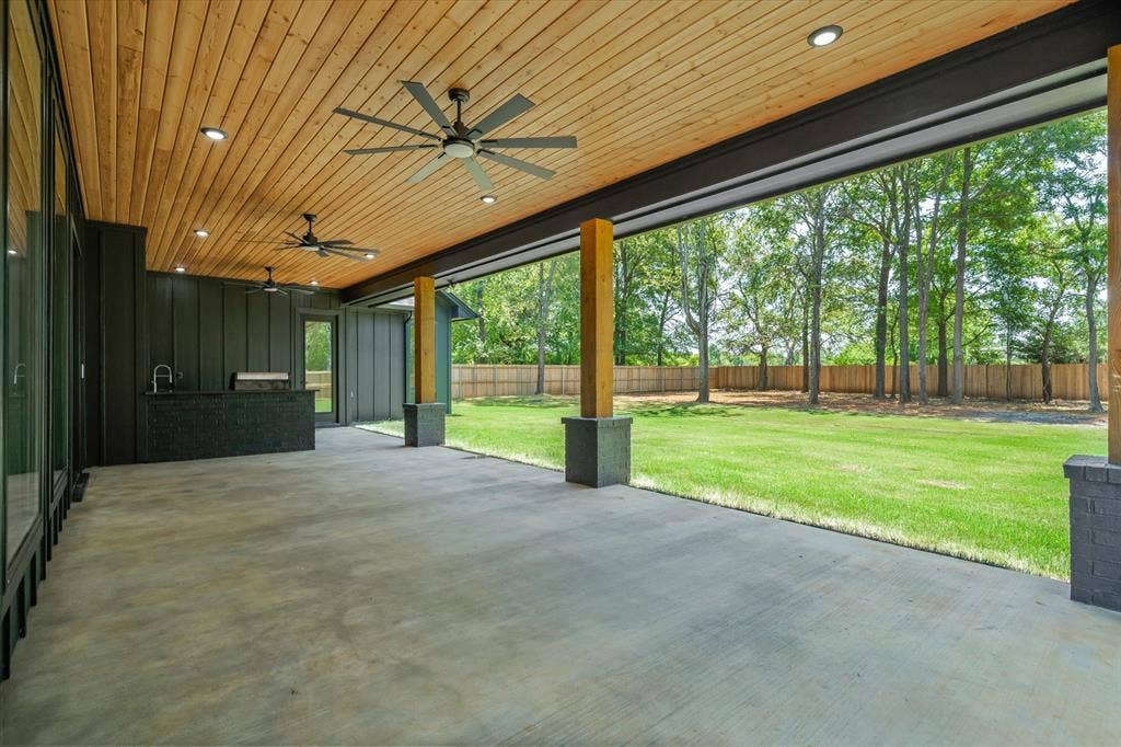 12253 Madison Xing, Bullard, TX 75757 Expansive covered patio featuring a wood-panel ceiling, multiple ceiling fans, and recessed lighting