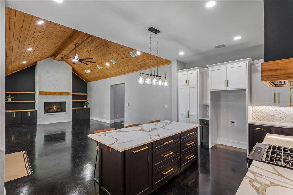12253 Madison Xing, Bullard, TX 75757 Open-concept living space featuring a vaulted wood-plank ceiling, white brick fireplace with wood mantel, and built-in shelving