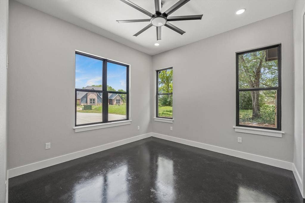 12253 Madison Xing, Bullard, TX 75757 Interior room featuring polished concrete flooring, light gray wall paint, and white baseboards
