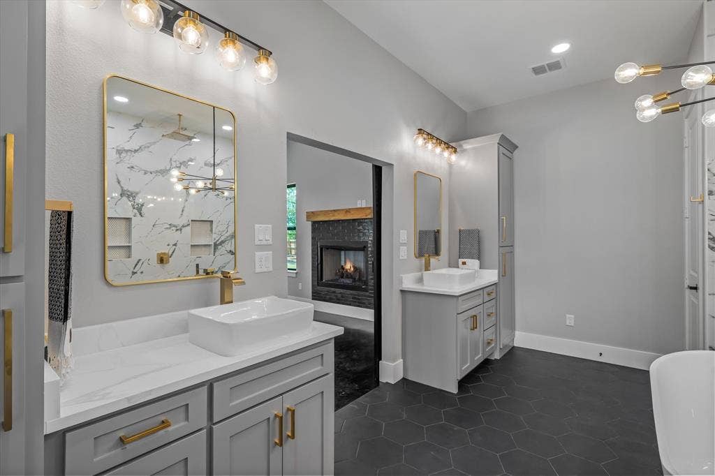 12253 Madison Xing, Bullard, TX 75757 Dual vanity featuring white vessel sinks, quartz countertops, and gold-finish hardware