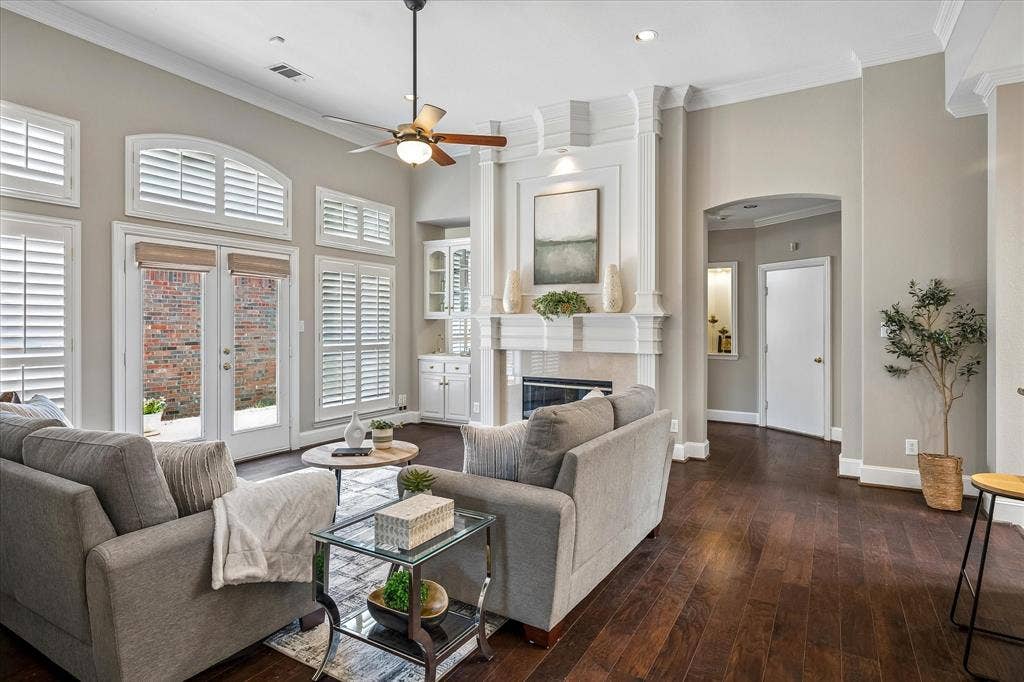 6708 Myrtle Beach Drive, Plano, TX 75093 Family room with amazing crown moldings, wet bar, fireplace, wood flooring and beautiful shutters.