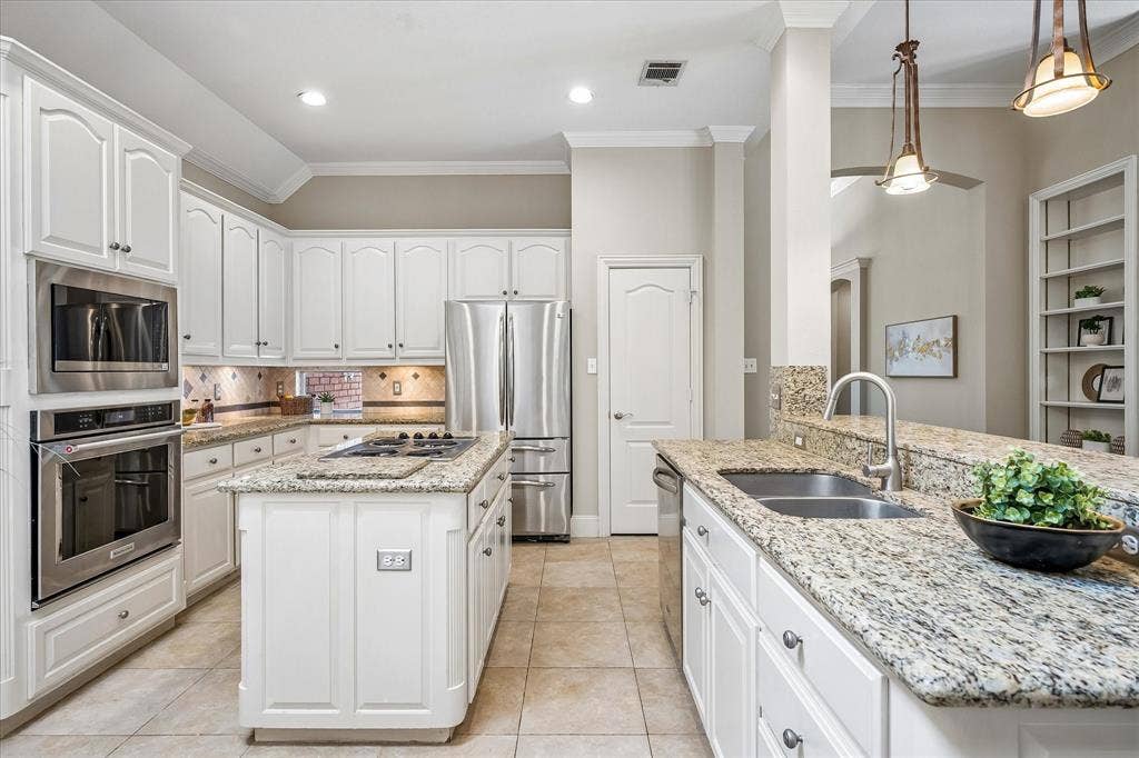 6708 Myrtle Beach Drive, Plano, TX 75093 Kitchen has granite counters and center island.