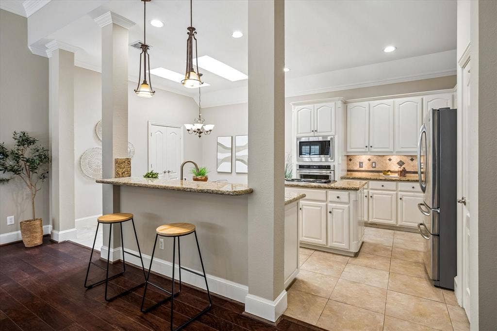 6708 Myrtle Beach Drive, Plano, TX 75093 Kitchen bar with pendant lighting.