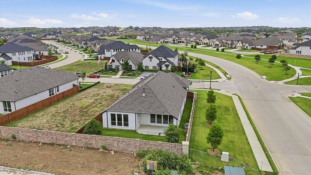 787 Cedarwood Court, Haslet, TX 76052 New construction residence featuring a light-colored exterior, multiple large windows, and a covered back patio