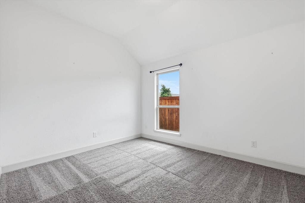 787 Cedarwood Court, Haslet, TX 76052 Bright interior space featuring a window with natural light, textured carpeting, white walls, and a neutral baseboard trim
