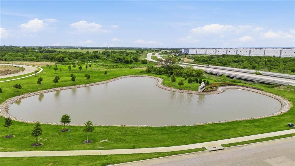 787 Cedarwood Court, Haslet, TX 76052 Pond feature with surrounding green space, paved pathways, and mature landscaping