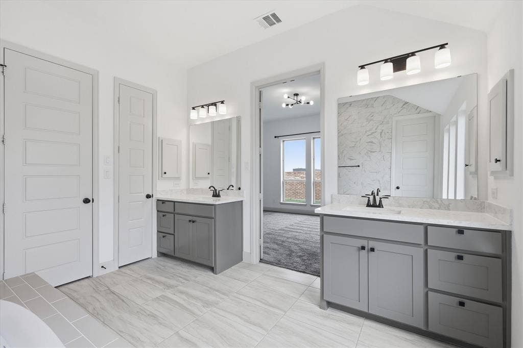 787 Cedarwood Court, Haslet, TX 76052 Dual vanity bathroom featuring gray cabinetry, light-toned countertops, and modern lighting fixtures