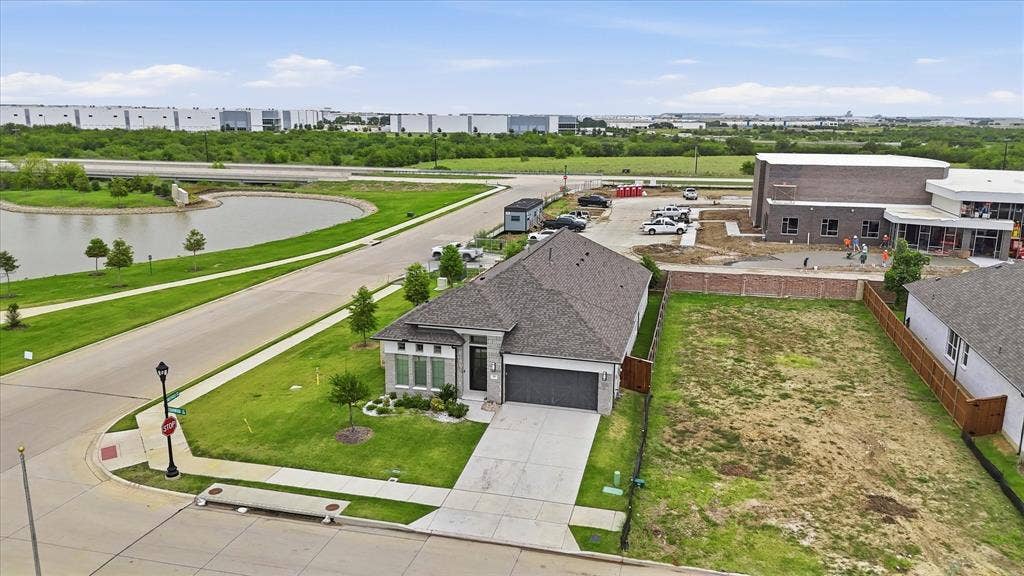 787 Cedarwood Court, Haslet, TX 76052 Contemporary single-story residence featuring a dark gray roof, light-colored stone and siding exterior, and an attached two-car garage