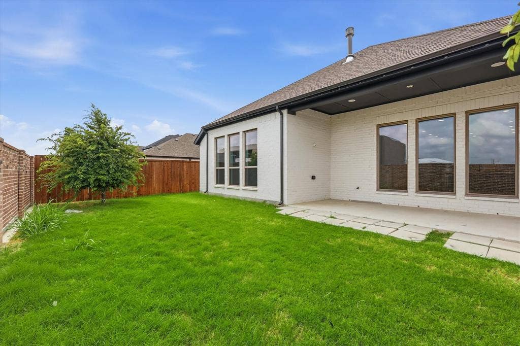 787 Cedarwood Court, Haslet, TX 76052 Expansive backyard featuring a lush green lawn, a mature tree, and a concrete patio