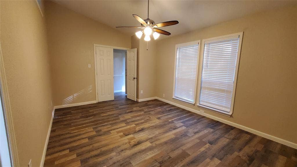 8440 Willow Creek Drive, Frisco, TX 75034 Unfurnished room featuring ceiling fan, dark hardwood / wood-style flooring, and lofted ceiling